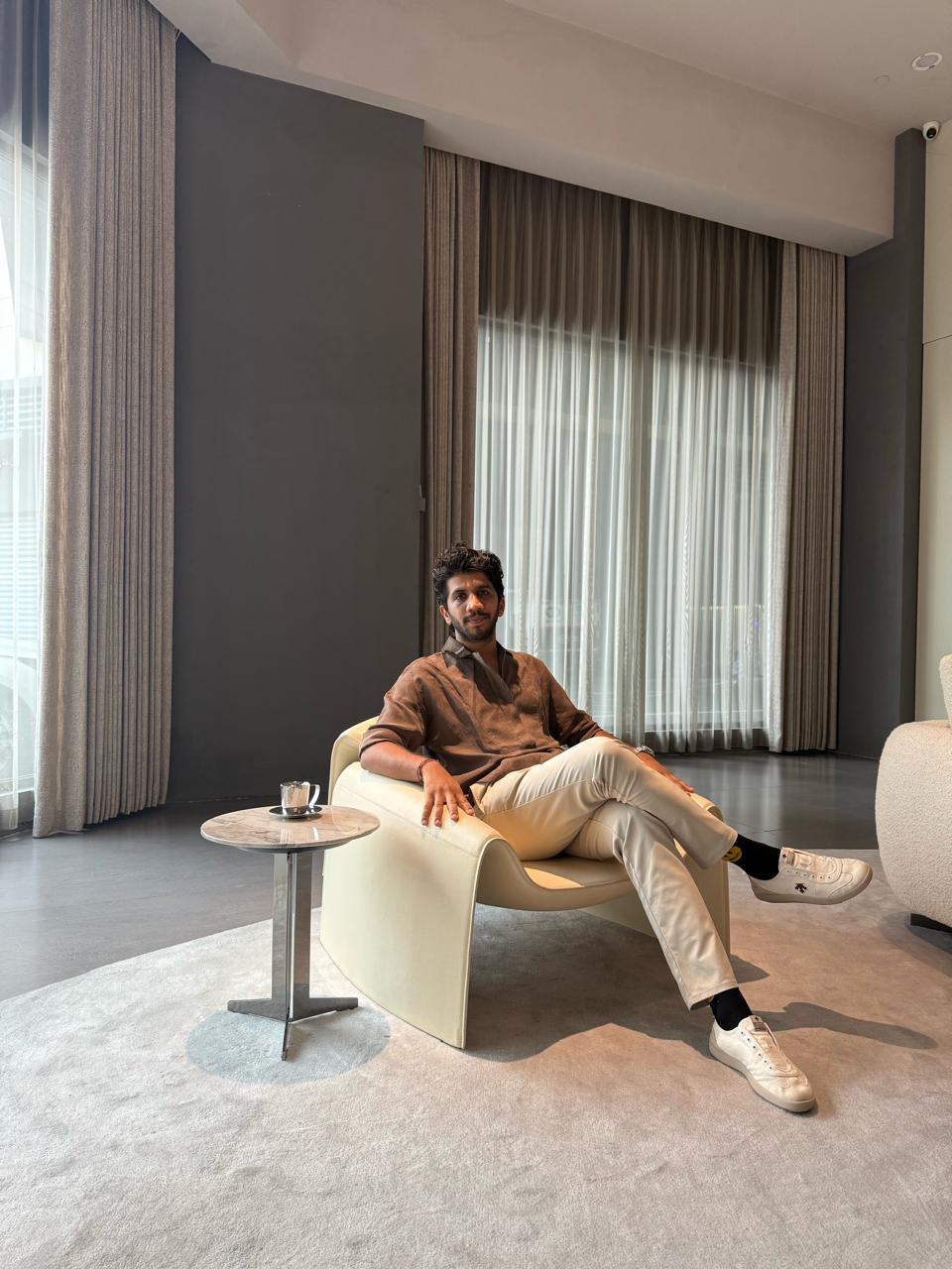 Shalin seated in a lounge chair